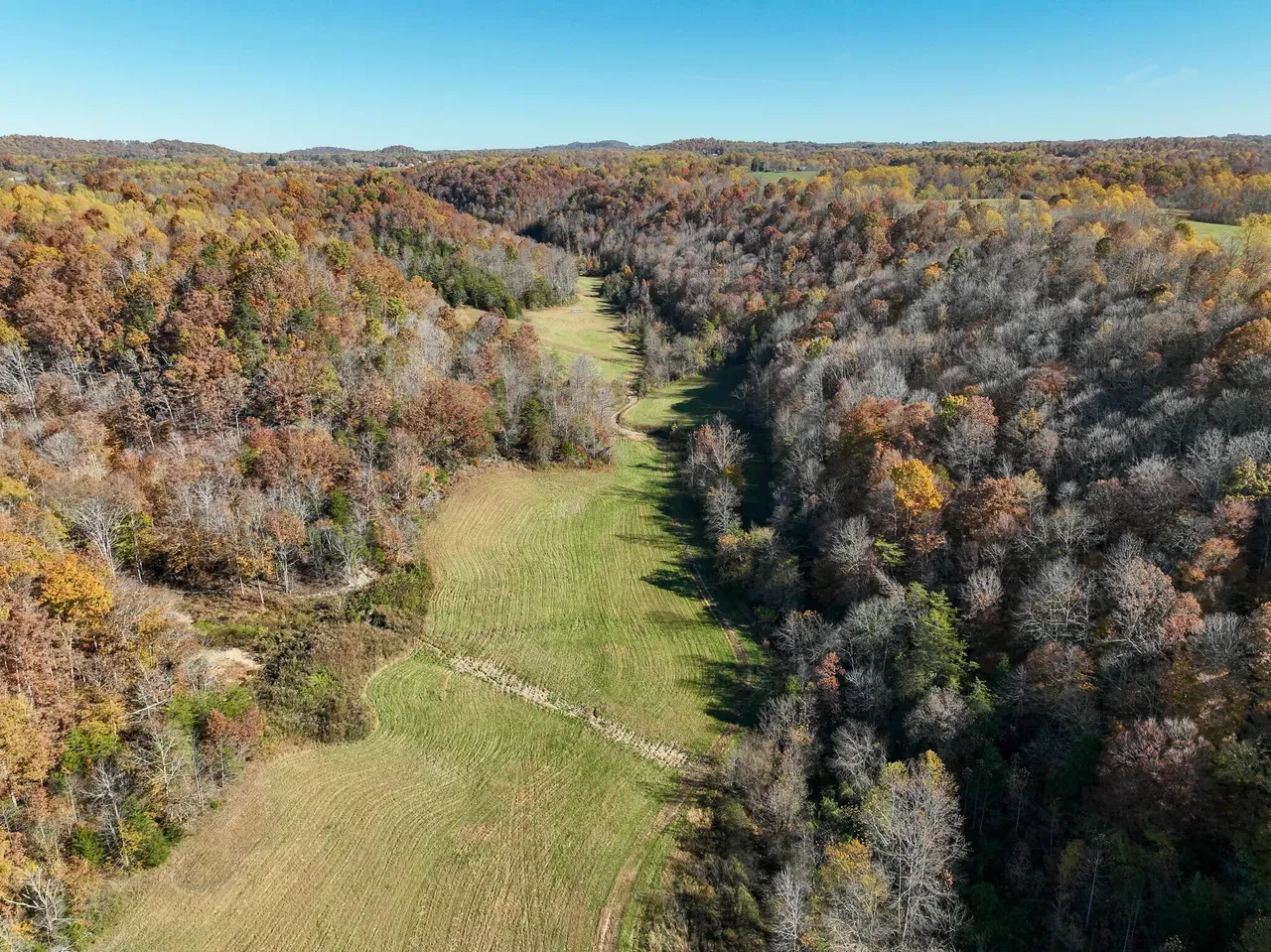 Field in fall with distant house