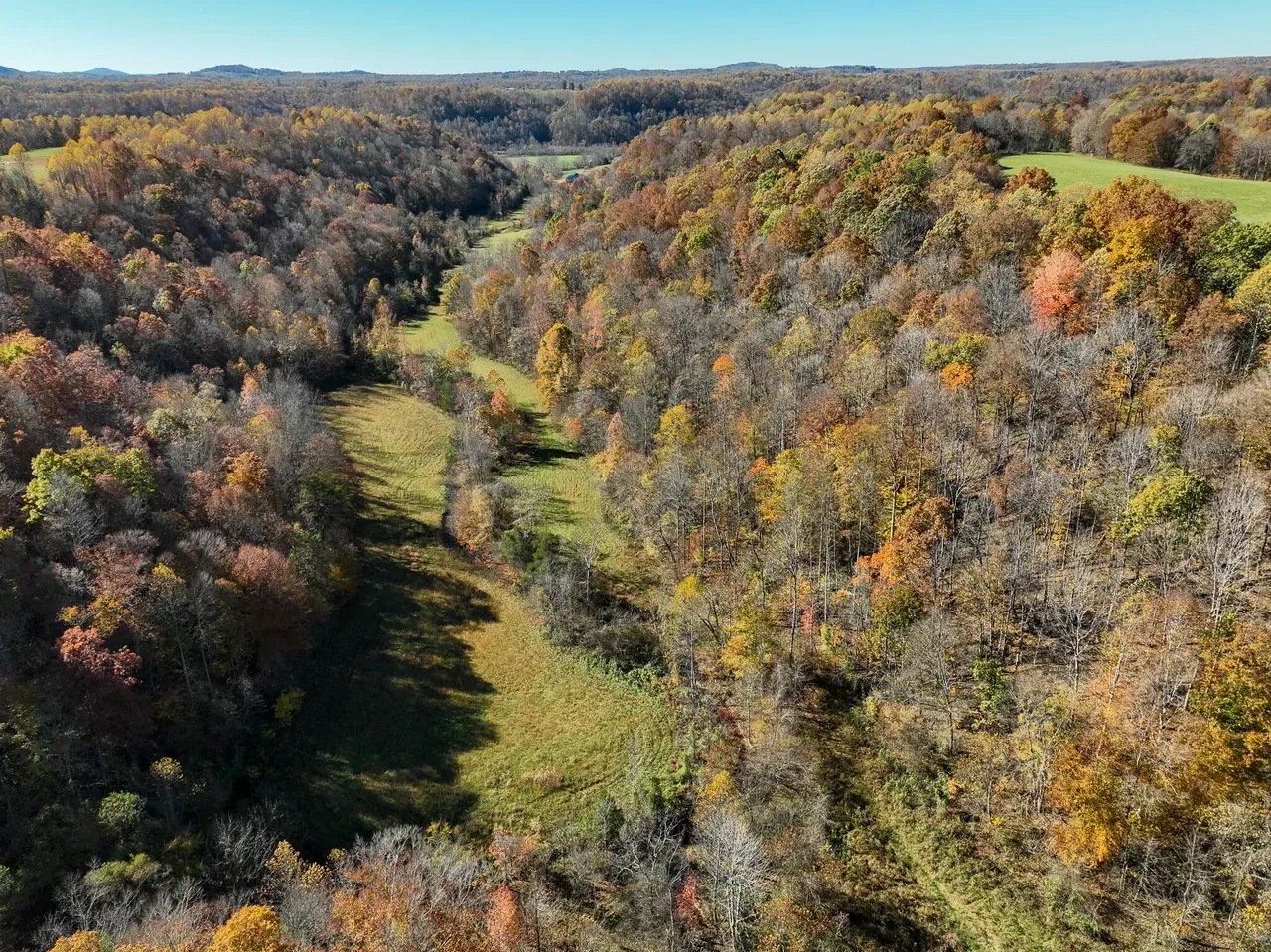 Aerial view of the valley with pond and building