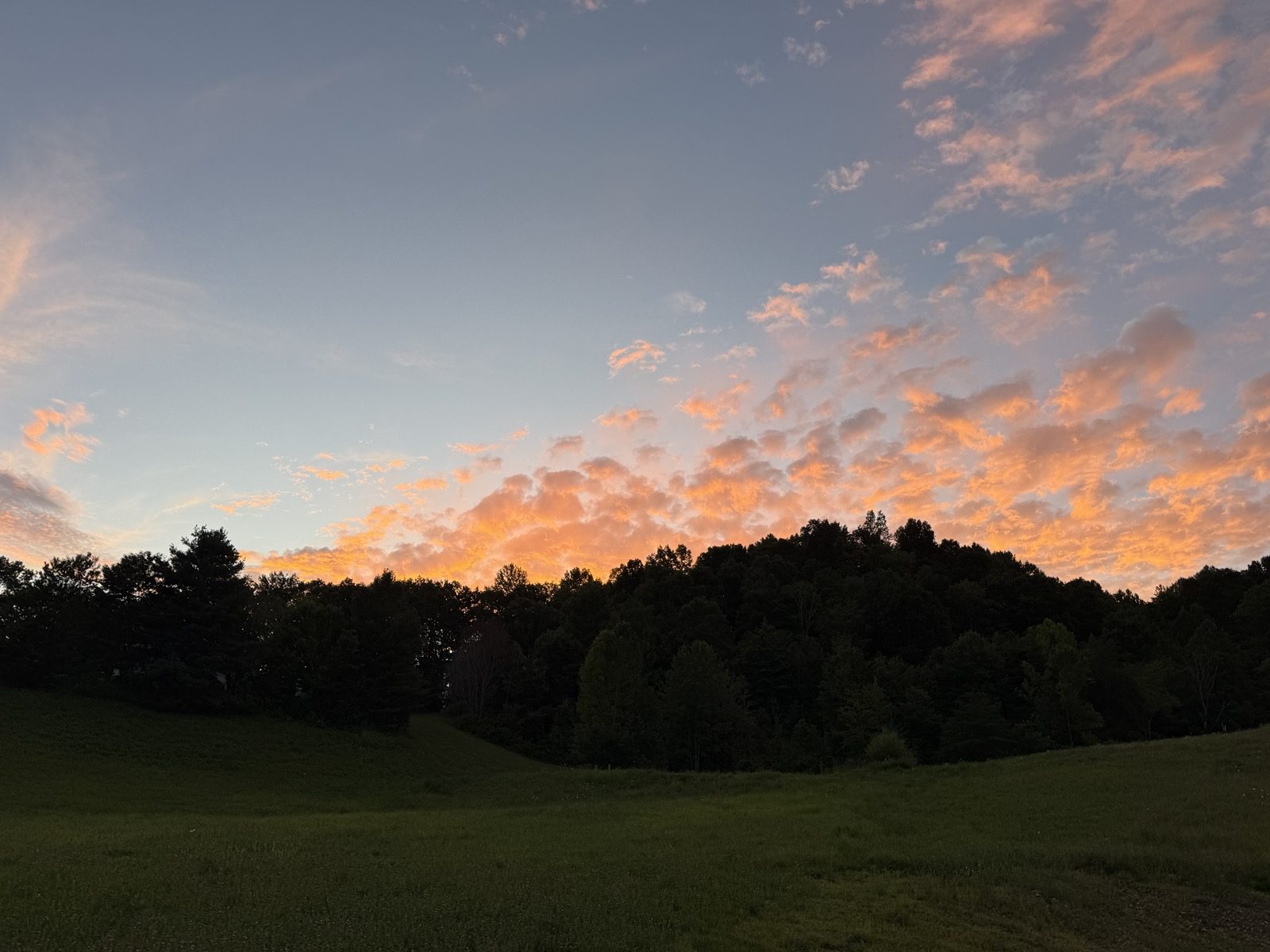 Sunset over the field and hills