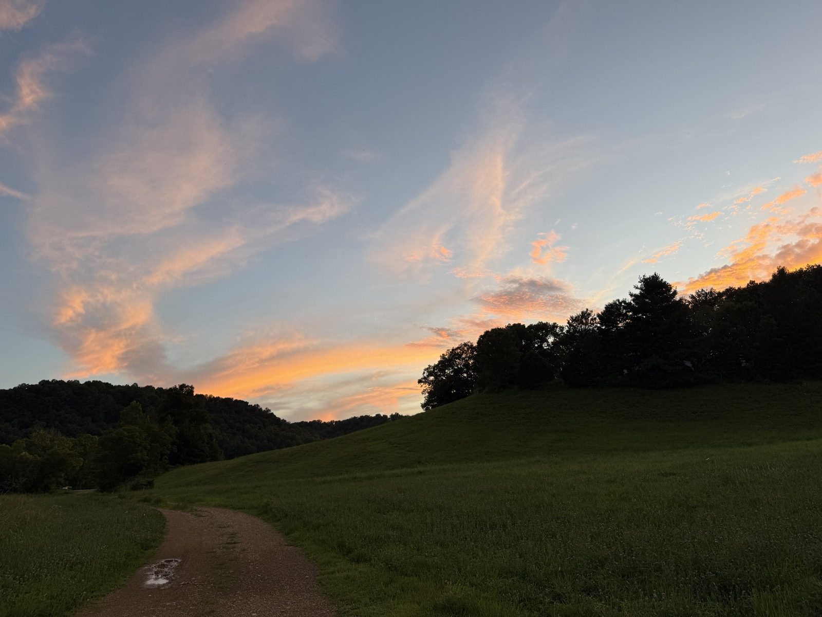 Sunset over the farm path and hills